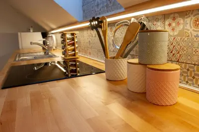a kitchen with utensils in cups on a counter at Apartments Laznica in Cerkno