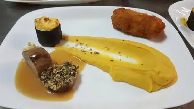 a plate of food with a banana and other foods at gostišče uh- planica in Rateče