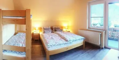 a bedroom with two bunk beds and a window at gostišče uh- planica in Rateče