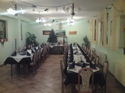 a dining room with tables and chairs and a christmas tree at gostišče uh- planica in Rateče
