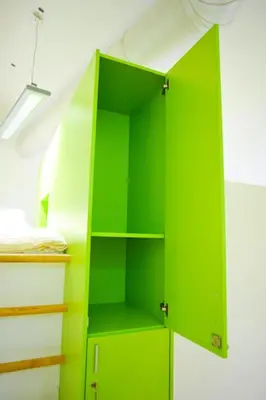 a green cabinet in the corner of a room at Youth Hostel Ajdovscina in Ajdovščina