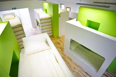 a room with two beds with green and white at Youth Hostel Ajdovscina in Ajdovščina