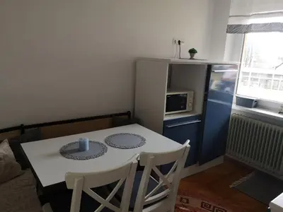 a small kitchen with a white table and chairs at Apartma Viktorija in Kranjska Gora