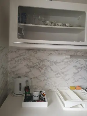 a kitchen counter with a coffee maker on a counter top at Apartma Viktorija in Kranjska Gora