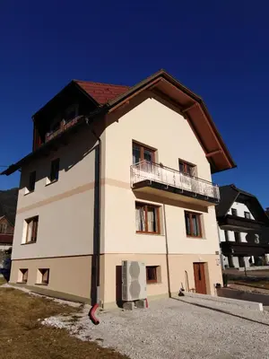 a large white building with a balcony on it at Apartma Viktorija in Kranjska Gora
