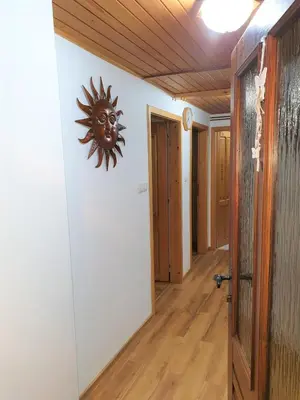 a hallway with a sun clock on the wall at Apartment Sonce in Bohinj