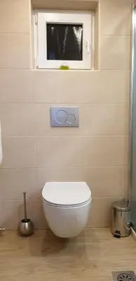 a bathroom with a white toilet and a window at Apartment Sonce in Bohinj
