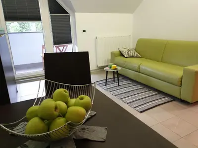 a living room with a bowl of green apples at Apartma Kurji vrh - Chicken top in Kranjska Gora