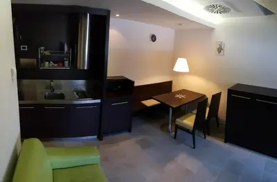 a room with a kitchen and a table and a table and chairs at Apartma Kurji vrh - Chicken top in Kranjska Gora