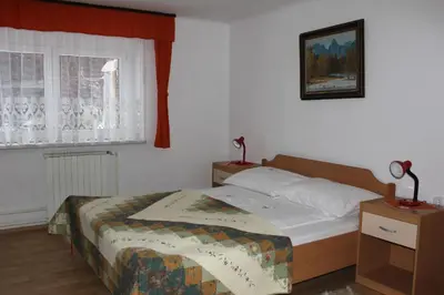 a small bedroom with a bed and a window at apartma Albina in Kranjska Gora