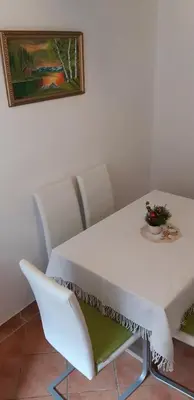 a white table and chairs in a room at apartma Albina in Kranjska Gora