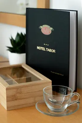 a wooden box with a glass bowl next to it at Hotel Tabor in Sežana