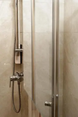 a shower in a bathroom with a glass door at Hotel Tabor in Sežana