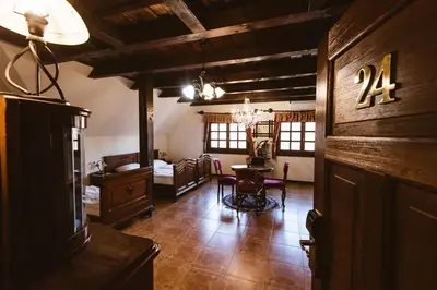 a room with a table and a room with a bedroom at Hotel Strk in Murska Sobota