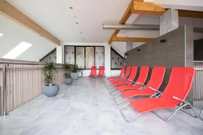 a row of red chairs sitting in a room at Hotel Strk in Murska Sobota