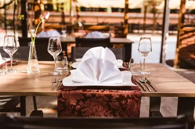 a table with a napkin and wine glasses on it at Hotel Strk in Murska Sobota