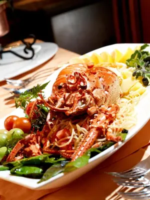 a plate of food with seafood and vegetables on a table at Hotel Strk in Murska Sobota