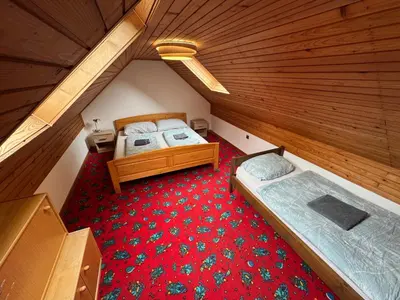 an overhead view of a attic bedroom with two beds at MaxDan Lodge in Kranjska Gora