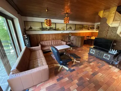 a living room with a couch and a television at MaxDan Lodge in Kranjska Gora