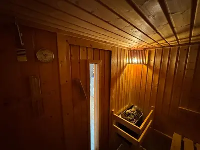 a wooden room with a clock on the wall at MaxDan Lodge in Kranjska Gora