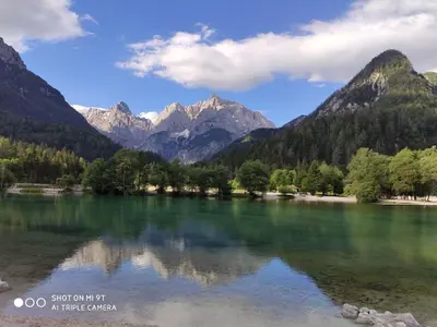 a view of a lake with mountains in the background at MaxDan Lodge in Kranjska Gora