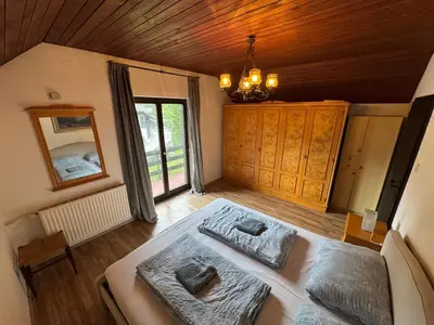 a bedroom with a bed and a large window at MaxDan Lodge in Kranjska Gora