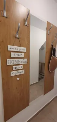 a mirror in a room with a door with signs on it at Apartment Alpska Astra in Kranjska Gora
