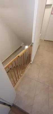 an empty room with a staircase and a tile floor at Apartment Alpska Astra in Kranjska Gora