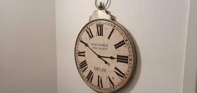 a pocket watch is hanging on a wall at Apartment Alpska Astra in Kranjska Gora