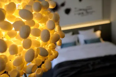 a wall covered with a bunch of yellow spheres at Hotel Cubo in Ljubljana