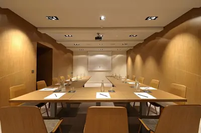 a large conference room with a long table and chairs at Hotel Cubo in Ljubljana