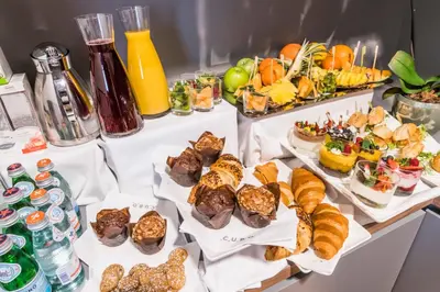 a table filled with different types of food and drinks at Hotel Cubo in Ljubljana