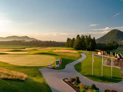 an aerial view of the golf course at a resort at Hotel Cubo in Ljubljana