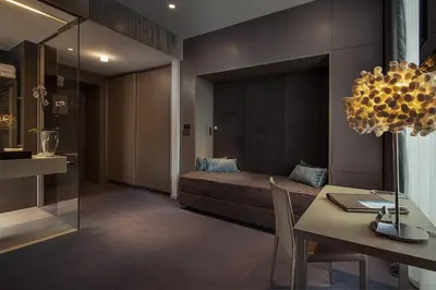 a room with a bed and a table and a dining room at Hotel Cubo in Ljubljana