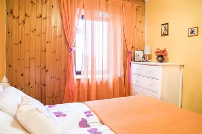 a bedroom with a bed and a dresser with a window at Počitniška hiša Pologar in Tolmin