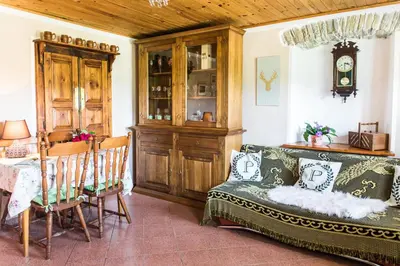a living room with a couch and a table at Počitniška hiša Pologar in Tolmin