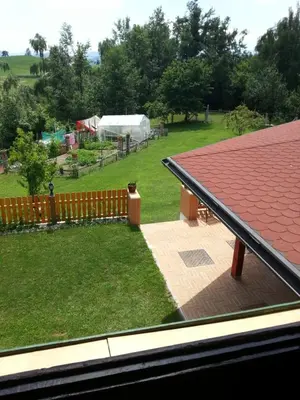 a view of a yard from a roof of a house at SOSTANJ VELENJE RAVNE SOBE ROOMS Vrtacnik d o o in Šoštanj
