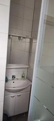 a bathroom with a sink and a mirror at SOSTANJ VELENJE RAVNE SOBE ROOMS Vrtacnik d o o in Šoštanj