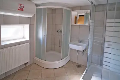 a bathroom with a shower and a sink at SOSTANJ VELENJE RAVNE SOBE ROOMS Vrtacnik d o o in Šoštanj