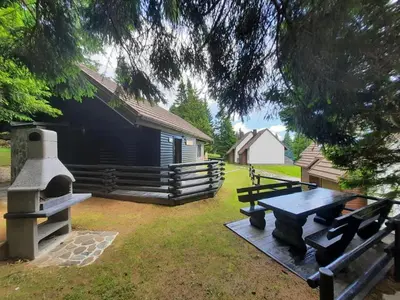 a picnic table in a yard next to a barn at Chalet Klara in Resnik