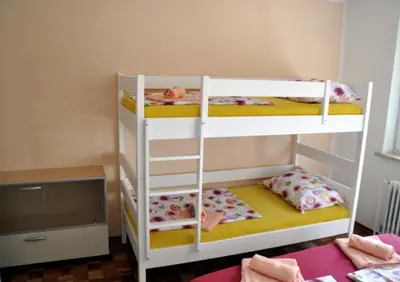 two bunk beds in a room with a television at Apartma BAJČI in Ajdovščina