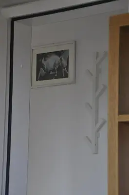 a picture hanging on a wall next to a door at Apartma BAJČI in Ajdovščina