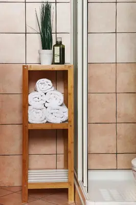 a wooden shelf with towels on it in a bathroom at Guesthouse Risnik in Divača
