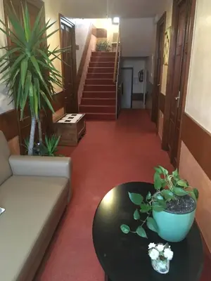 a living room with a couch and a table and stairs at Guesthouse Risnik in Divača