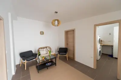 a living room with two chairs and a table at Central Apartments with Parking in Ljubljana