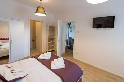 a bedroom with a bed with towels on it at Central Apartments with Parking in Ljubljana