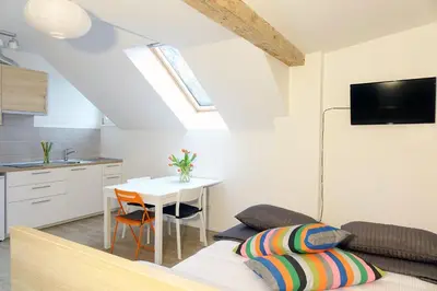 a living room with a table and a couch at Central Apartments with Parking in Ljubljana