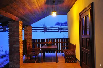 a dining room with a table and chairs and a window at Apartments Mali Raj in Dolenci