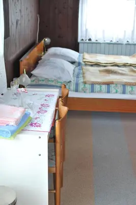a bedroom with a bed and a table with chairs at Farm Stay Bogša in Ormoz