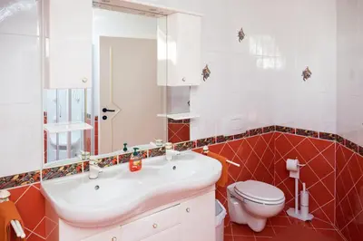 a bathroom with a white sink and a toilet at Modrin Apartments in Kamnik